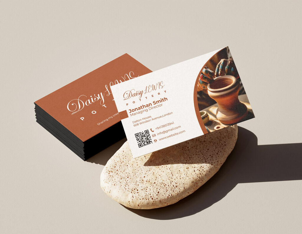 Elegant pottery studio business card mockup with ceramic artwork, QR code, and professional contact information.