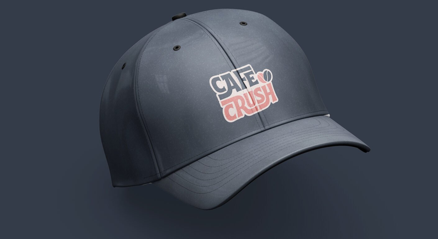 Dark gray baseball cap mockup featuring the Cafe Crush logo embroidered on the front panel.