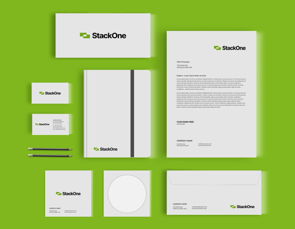 Green and white corporate stationery branding mockup with logo, business cards, letterhead, notebook, envelope, and office materials.