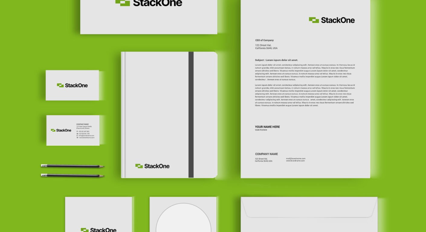 Green and white corporate stationery branding mockup with logo, business cards, letterhead, notebook, envelope, and office materials.