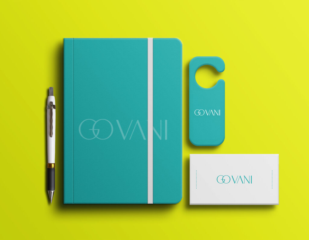 Turquoise branded notebook, business card, pen, and door hanger mockup on a bright yellow background.